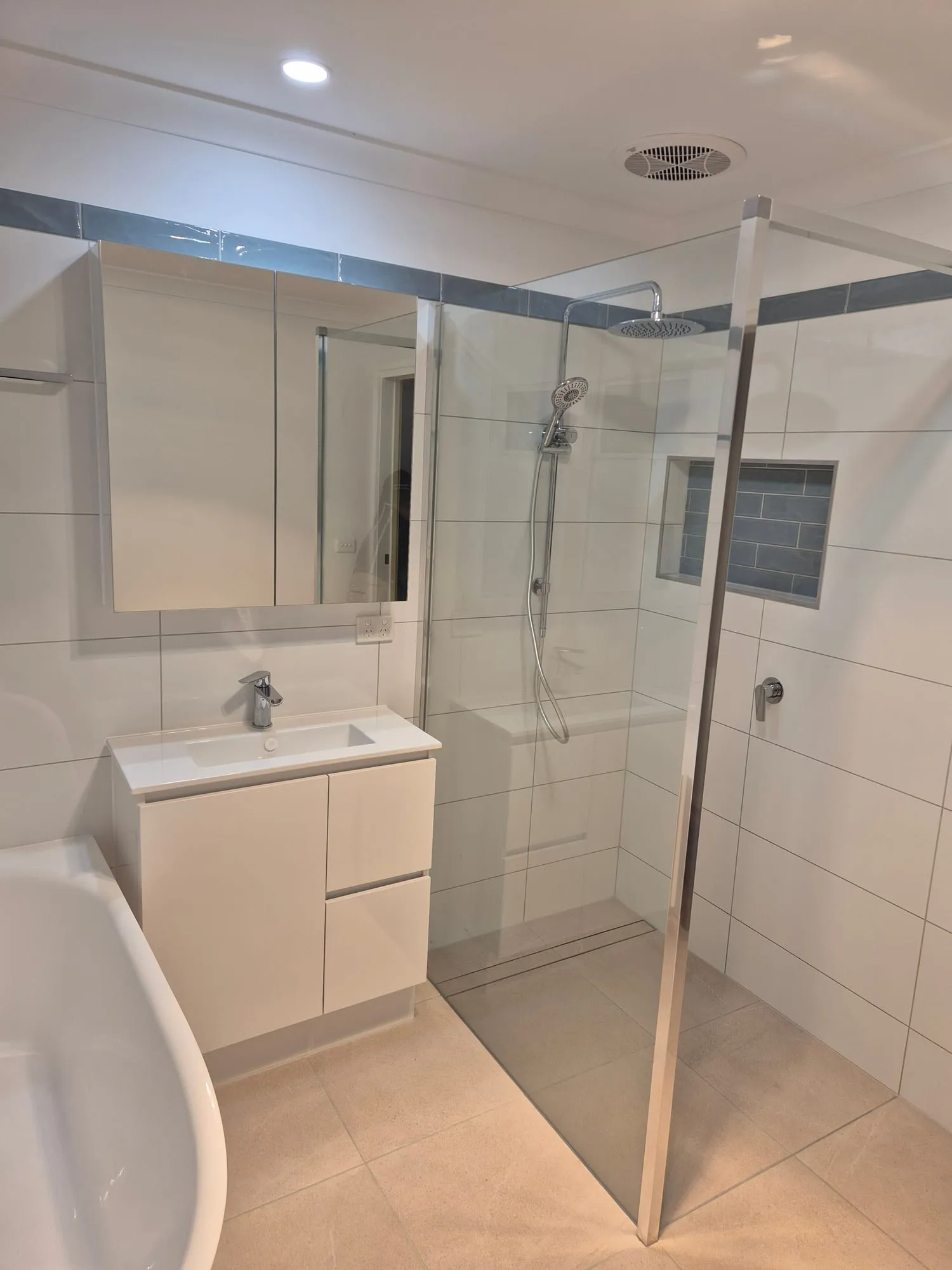 Vanity and shower seen from the bath, with a niche in the shower wall