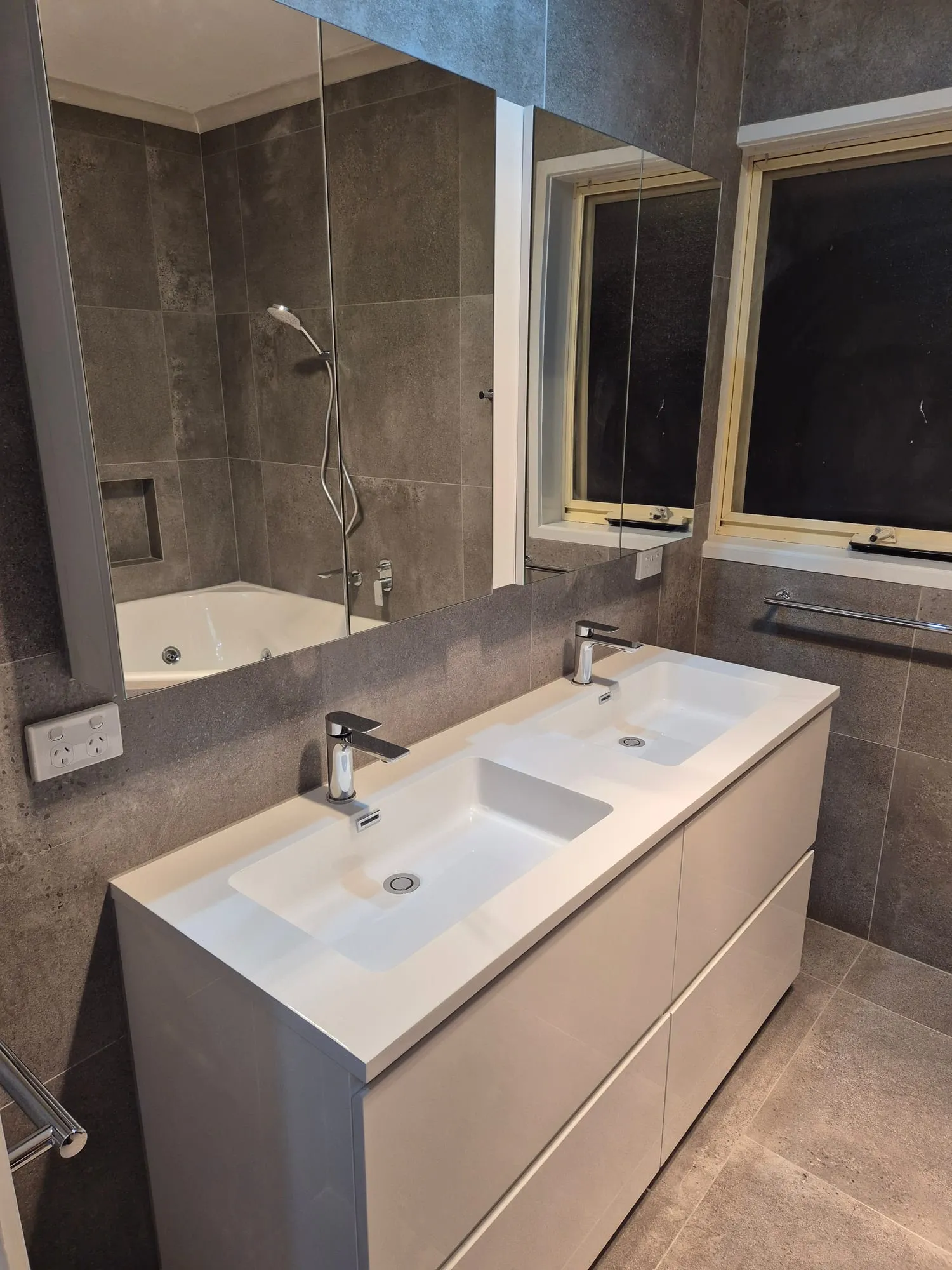 Wall-hung double vanity with twin basins, below a mirror