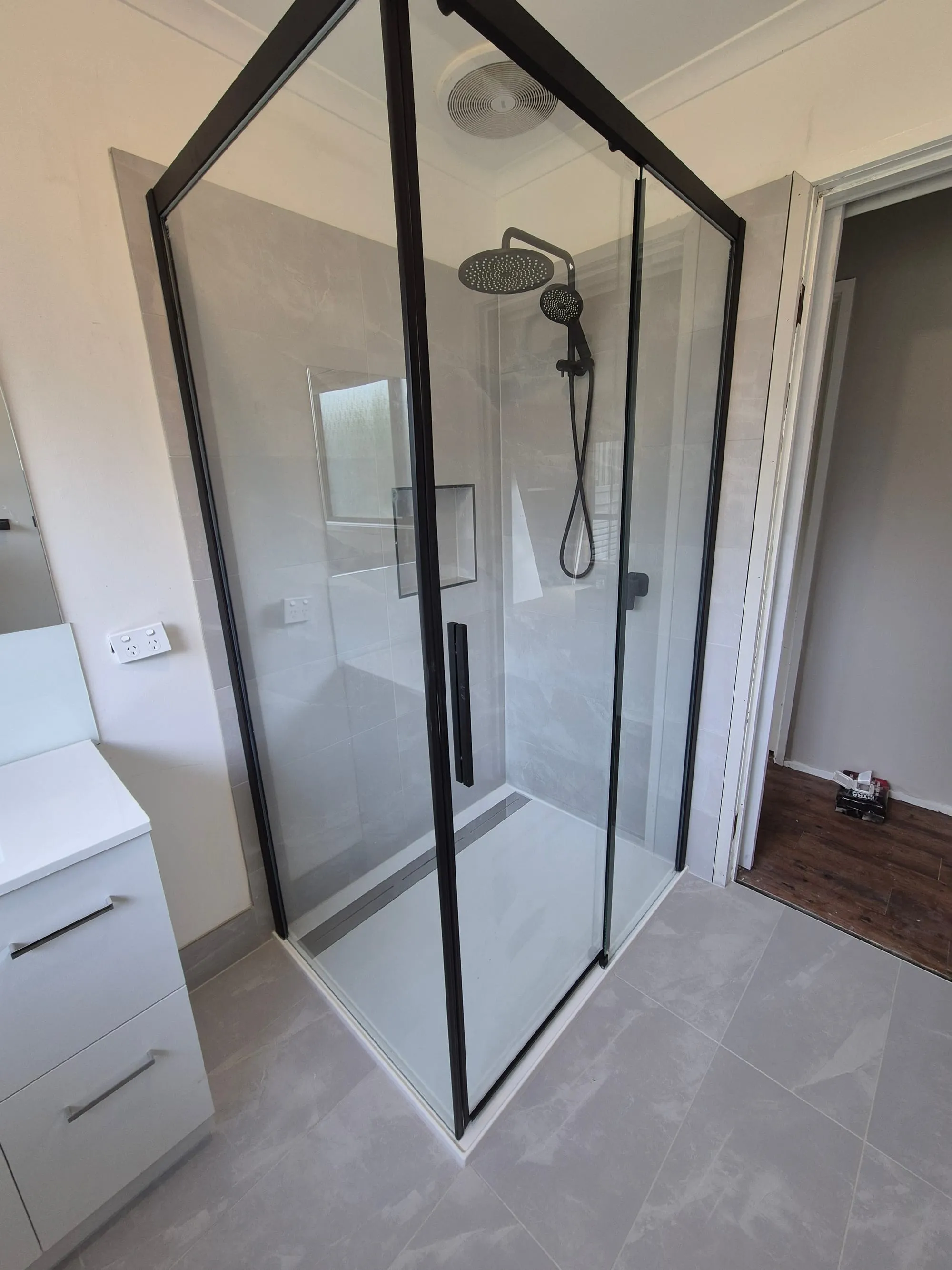 Black-framed shower screen seen from the doorway