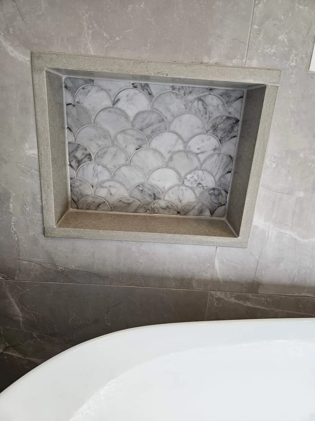 Close view of the fan-shaped marble mosaic set into the niche